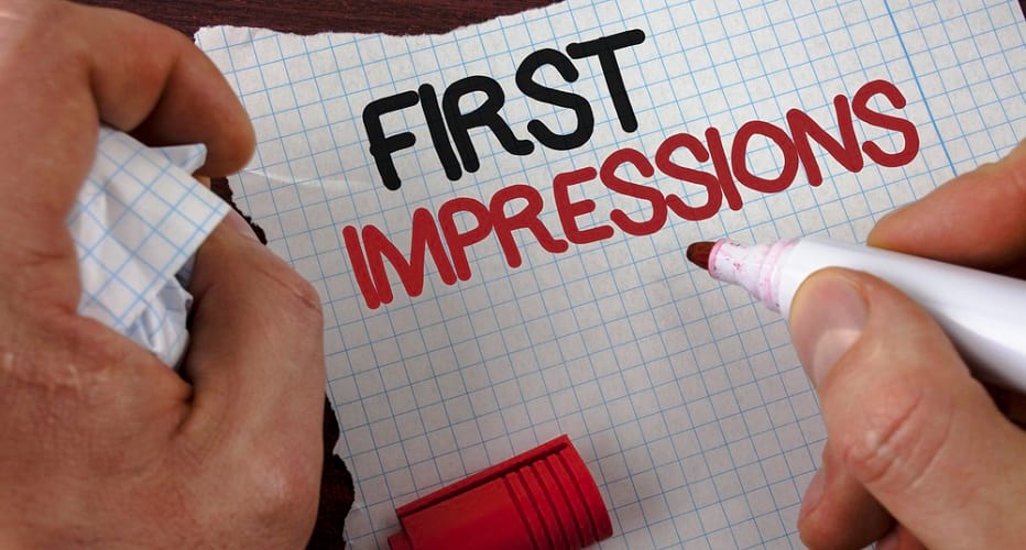 A hand writting on paper "first impresssions" with a red marker