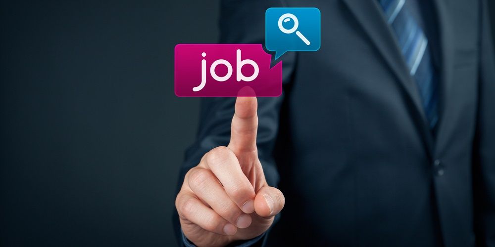 a man on a suit touching a screen that says "job" with a loupe