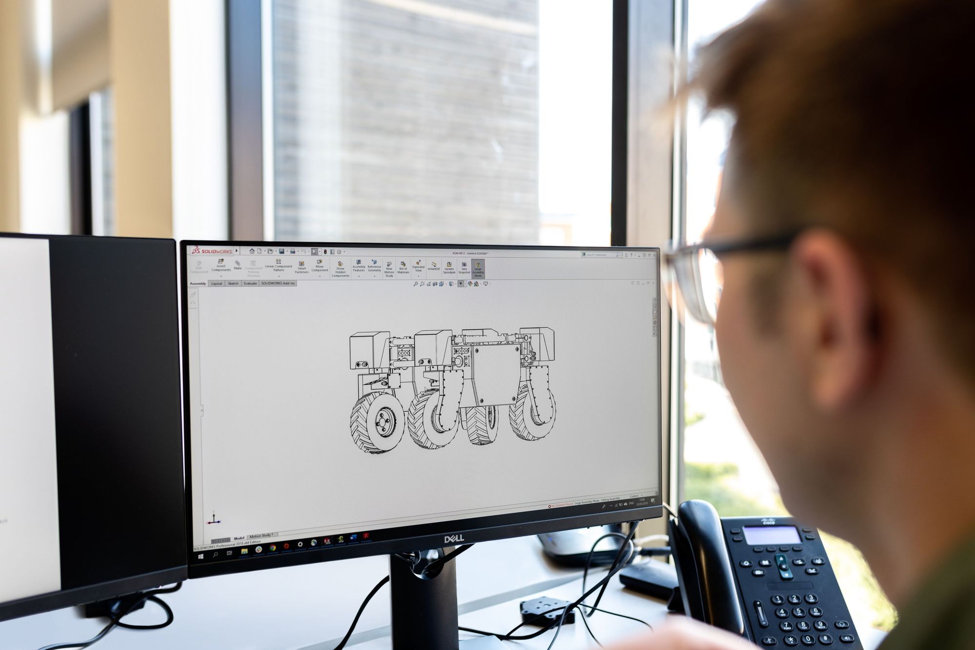 An employee working on an engineering project on a monitor